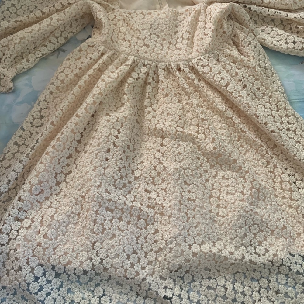 Storia mini dress is made from floral crochet- lace with voluminous sleeves